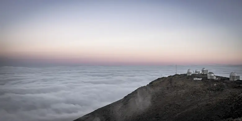 Cúpulas del Observatorio La Silla asomando sobre un mar de nubes en la cordillera de Coquimbo